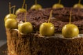 Homemade chocolate cake sweet pastry dessert with brown icing, green decorative cherries