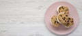 Homemade Chocolate Chip Cookie Ice Cream Sandwich on a pink plate on a white wooden surface, top view. Overhead, from above, flat Royalty Free Stock Photo