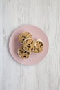 Homemade Chocolate Chip Cookie Ice Cream Sandwich on a pink plate on a white wooden table, top view. Overhead, from above, flat Royalty Free Stock Photo