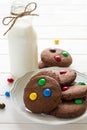Homemade chocolate cookies decorated with colored candy drops and bottle of milk Royalty Free Stock Photo