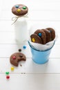 Homemade chocolate cookies decorated with colored candy drops and bottle of milk Royalty Free Stock Photo