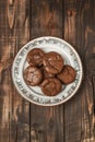 Homemade chocolate cookies with sea salt on a rustic plate, wooden background Royalty Free Stock Photo