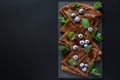 Homemade chocolate crepes served with blueberries, sauce and mint leaves on slate plate. Selective focus. Top view. Copy space Royalty Free Stock Photo