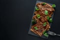 Homemade chocolate crepes served with blueberries, sauce and mint leaves on slate plate. Selective focus. Top view. Copy space Royalty Free Stock Photo