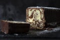 Homemade chocolate marble cake on a slate cutting board covered with icing sugar. Royalty Free Stock Photo