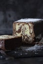 Homemade chocolate marble cake on a slate cutting board covered with icing sugar. Royalty Free Stock Photo