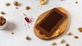 Homemade chocolate in mold. Chocolate bar, nuts, freeze dried fruits on white background top view. Chocolatier, confectionery