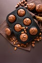 Homemade chocolate muffins brownies with cinnamon, almonds and hazelnuts on brown paper background Royalty Free Stock Photo