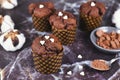 Homemade chocolate muffins with heart shaped sugar sprinkles in paper case with cup and spoon with cocoa powder Royalty Free Stock Photo