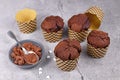 Homemade chocolate muffins in paper case with cup and spoon with cocoa powder on gray stone background Royalty Free Stock Photo