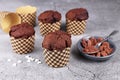 Homemade chocolate muffins in paper case with cup and spoon with cocoa powder and star shaped sugar sprinkles Royalty Free Stock Photo