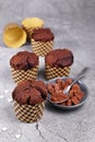 Homemade chocolate muffins in paper case with cup and spoon with cocoa powder and star shaped sugar sprinkles Royalty Free Stock Photo