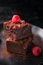 Homemade chocolate sweet brownies cakes with cherry and raspberries on a dark background Royalty Free Stock Photo