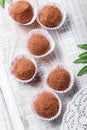 Homemade Chocolate truffles candy dessert on wooden background close up. Delicious chocolate praline with decor