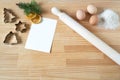 Homemade Christmas cookies. Blank greeting card or business card on wooden work table. Rolling pin, cookie cutters,fir tree brach Royalty Free Stock Photo