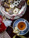 Homemade Christmas cookies with a cup of tea, top view over a rustic wood background