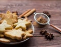 Homemade Christmas cookies and spices on wooden background Royalty Free Stock Photo