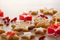 Homemade Christmas cookies with white icing in shape of star, fir and snowflakes and red candles on wooden table background Royalty Free Stock Photo