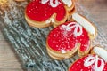 Homemade christmas ginger cookies in the form of red mittens on a glass plate on a wooden table. Christmas card