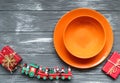 Homemade christmas gingerbread cookies in orange plates and train, presents on gray wooden background. Royalty Free Stock Photo