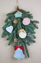 Homemade Christmas tree branch decoration of toys   made of wood, plaster and  bows Royalty Free Stock Photo