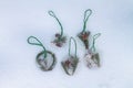 Homemade Christmas tree decorations made of ice and spruce twigs lie on white snow Royalty Free Stock Photo