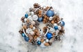 Homemade Christmas wreath in trendy colors - Classic Blue and White on a white concrete background. The concept of the