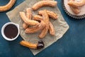 Homemade churros with cinnamon sugar on parchment