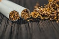 Homemade cigarettes and tobacco on the brown wooden table Royalty Free Stock Photo