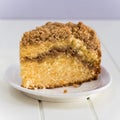 Homemade Cinnamon crumble coffee cake on white wooden background