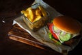 Homemade classic burger with beef brisket, cheese, onion, tomato and potato chips Royalty Free Stock Photo