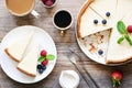 Homemade classical New York cheesecake and coffee on wooden table