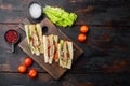 Homemade club sandwich made with turkey, bacon, ham, tomato, on old wooden table, top view with copy space for text Royalty Free Stock Photo