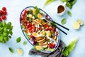 Homemade Cobb salad served in an oval dish