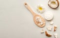 Homemade coconut products on white wooden table background. Oil, scrub, milk, lotion, mint and himalayan salt from top