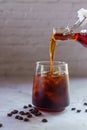 Homemade cold brew coffee being poured in to a glass with iced Royalty Free Stock Photo