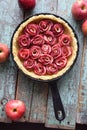 Homemade comfort food. Raw apple rose pie in cast iron pan with Royalty Free Stock Photo