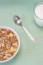 Homemade cooked oatmeal cereals with ceramic mug, metal spoon and glass of milk on blue background vertical Royalty Free Stock Photo