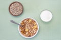 Homemade cooked oatmeal cereals with ceramic mug, metal spoon and glass of milk and sunflower seeds above view on blue background Royalty Free Stock Photo