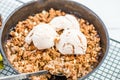 Homemade cooked rhubarb and apple crumble with oatmeal and vanilla ice cream Royalty Free Stock Photo