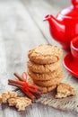 Homemade cookies, cinnamon sticks, red teakettle and tea cup