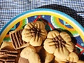 Homemade cookies in a colorful plate on blue white tablecloth