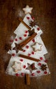 Homemade cookies folded in the form of a Christmas tree with cinnamon on a baking sheet with powdered sugar Royalty Free Stock Photo