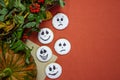 Homemade cookies in the form of a head with a painted scary face on white glaze, against the background of an orange