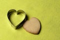 Homemade cookies with a metal baking dish in the shape of a heart on a yellow background Royalty Free Stock Photo