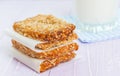 Homemade cookies, muesli bars with glass of milk on a wooden table