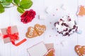 Homemade cookies in shape of heart with Love you lettering on the white wooden table with greeting card, flower, gift box and cup Royalty Free Stock Photo