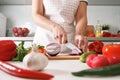 Homemade cooking. Woman in the kitchen cutting red onions on a chopping board. Healthy fresh food Royalty Free Stock Photo