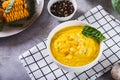 Homemade corn soup with spices and basil in a bowl on the table Royalty Free Stock Photo