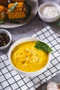 Homemade corn soup with spices and basil in a bowl on the table vertical view Royalty Free Stock Photo